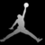 Pixelated grayscale silhouette of a basketball player mid-air with one arm extended upward holding a ball, legs spread wide in a jump pose against black background.
