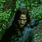 repeated character portraits with long dark hair and blue clothing against a green foliage background, showing subtle pose variations