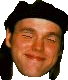 Six -aligned headshots of a person wearing a black beret, showing sequential facial expression changes from neutral to smiling across two