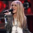 A pixelated image of a person with long blonde hair singing into a microphone, alongside two purple with pink text reading 'Annah Montana' and a small heart symbol