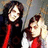 Two people stand side-by-side against a textured background, with purple text reading 'how do we look??' on the right.