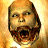 Pixelated image of a bald man with long hair and beard, mouth open in a shout, next to stylized 'DOOM' text on black background.