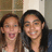 Two people with long dark hair smiling closely together in a pixelated static image.