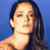 Pixelated static image of a person with long dark hair against blue background, likely celebrity portrait icon.