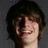 A static image with a blue background, green pixelated text, and a small photo of a person with dark hair on the top left.