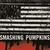 A pixelated American flag with black and white stripes and a red bottom section, featuring a dark star field on the left.
