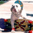 Pixelated image of a dog wearing a blue hat, standing on a patterned surface with green text reading 'Yo! My Dog Is Soo Pimp!!'