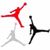 Red, gray, and black silhouettes of a basketball player in mid-air pose appear in a with one gray rectangle replacing a black silhouette in the bottom-right corner