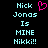 Pixelated text reads 'Nick Jonas Is MINE Nikki!!' with a pink heart symbol above the name on black background.