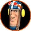 A circular icon shows a cartoon character with a blue and white helmet, red goggles, yellow headphones, and a blue neck guard, set against a black background with an orange border.