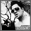 Black-and-white image of a person with dark hair and sunglasses, wearing a white shirt, with a star symbol and text reading 'JOHNNY KNOXVILLE' below.