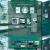 Pixelated green and blue interface with multiple rectangular elements and a central pinkish bar.