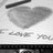 Black background with red text and a grayscale heart drawing on paper.