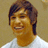 Pixelated portrait of a person with brown hair and a white shirt against a beige background, with pink text and symbols on a black overlay.