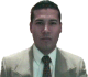 Two side-by-side frames of a person in a light suit and dark tie showing facial expression changes from neutral to surprised.