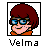 Pixelated cartoon character icon with red hair, blue glasses, orange collar, and black border frame showing only the head against white background.