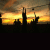 Silhouetted figures on a beach at sunset with text forming 'volleyball are you game?', transitioning from partial to full phrase.