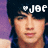 Pixelated close-up of a person with dark hair against a dark background, featuring white text and a heart symbol above the head.