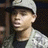 Pixelated close-up of a person wearing a white cap and light-colored shirt, with dark hair visible beneath the cap.