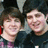 Two people in a photo on the left, blue pixelated text on green background reading "I DON'T BELIEVE YOU" and "HUG ME BROTHER brother from another mother", static image.