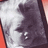 Pixelated grayscale image of a person's face on left, bright yellow background with blue text on right.