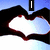 Animated icon shows hands forming a heart shape with changing text overlays: 'I', then 'LOVE', then 'LEANN' against blue sky background.