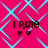A pink background with cyan diamond-shaped lines and four identical text blocks reading "I Rule" with two hearts below each.