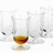 A pixelated image shows a glass of amber liquid with blurred background figures, accompanied by red text reading "Beauty Is In The Eye Of the Beer-Holder" on black.