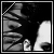 Black-and-white pixelated image of a person's face with visible ear and hair, featuring text overlays in six