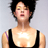 Static pixelated image of a person with short dark hair wearing a black sleeveless top against a light gray background.