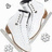Pixelated image of a white ice skate with brown accents and black laces, surrounded by small snowflake shapes on a white background.