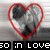 A heart-shaped icon with a grayscale image of a person inside, surrounded by red outline, with text below reading 'so in love' in white and red letters.