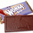 A pixelated image shows a brown rectangular object with a blue and white patterned fabric draped over it, featuring red and yellow accents.