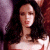 A pixelated image of a woman with long dark hair wearing a red strapless top, positioned next to green text reading 'Original Icons .com' on a solid background.