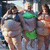 Pixelated image of three muscular figures with green accents on a light blue background, accompanied by text reading "ewelllook how fat they are!" and "THAT'S ERIKA ANA & LUISA!".