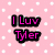 Pink polka-dot background with black-outlined pink text reading 'I Luv Tyler' in two lines, right side has solid gray rectangle.