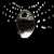 A sequence of grayscale animated frames showing a spherical object with a dark top and light bottom, emitting small white particles from its sides against a black background.