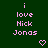 Green background with pink pixelated text reading 'i love Nick Jonas' and two pink heart icons below the text.