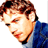 Static pixelated image of a person's face and upper torso in blue clothing with brown hair, viewed from the side against a white background.