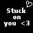 Black background with white pixelated text reading 'Stuck on you <3' and a heart symbol above the left side of the text.
