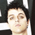 A pixelated image showing a person's face on the left and bold text reading "GREEN DAY" on the right against a black background.