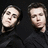 Four of a person in a black turtleneck against a dark background, showing head movement from left to right