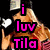 A woman with long blonde hair in a red top makes hand gestures against a black background, with text overlay.