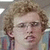 A 50x50 pixel animated buddy icon featuring a character with curly hair and red text that changes between frames.