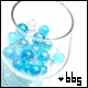 Two side-by-side frames of a glass filled with blue and white spheres, with text below each frame.