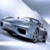Pixelated static image of a silver sedan with dark windows and black trim against light blue background.