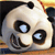 Pixelated close-up of a panda's face with large black eye patches, white fur, and a subtle smile, set against a blurred background of warm colors.