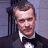 A 48x48 pixel buddy icon featuring a split composition with a man in formal attire on the left and green text on a dark background on the right, displayed as part of an animated contact sheet.