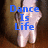 A pixelated image of a person's lower legs and feet in white shoes against a brown background, with blue text reading "Dance Is Life" on the left and "la danse est la vie" on the right.
