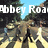 Pixelated image of a road with yellow lines, trees, and text overlays including 'Abbey Road The Beatles' and '1969'.
